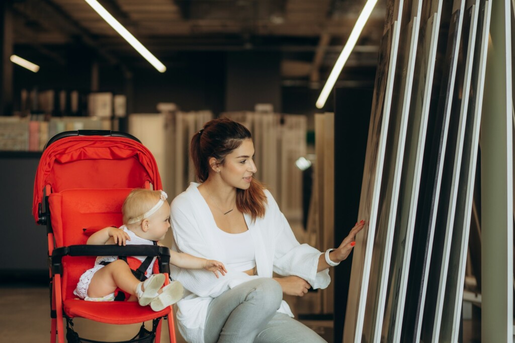 a young mother with her daughter chooses tiles for the home in a hardware store