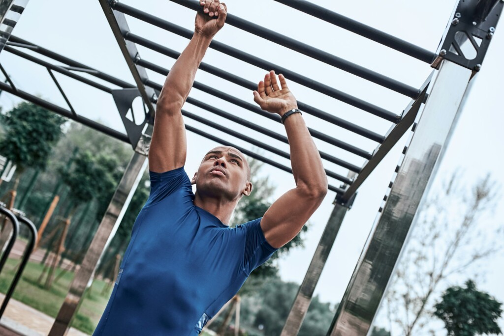 An african man is exercising at open air gym