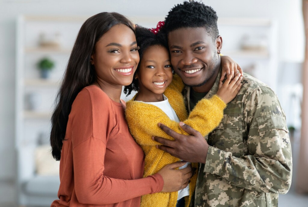 Military Family. Portrait Of African American Male Soldier With Wife And Daughter