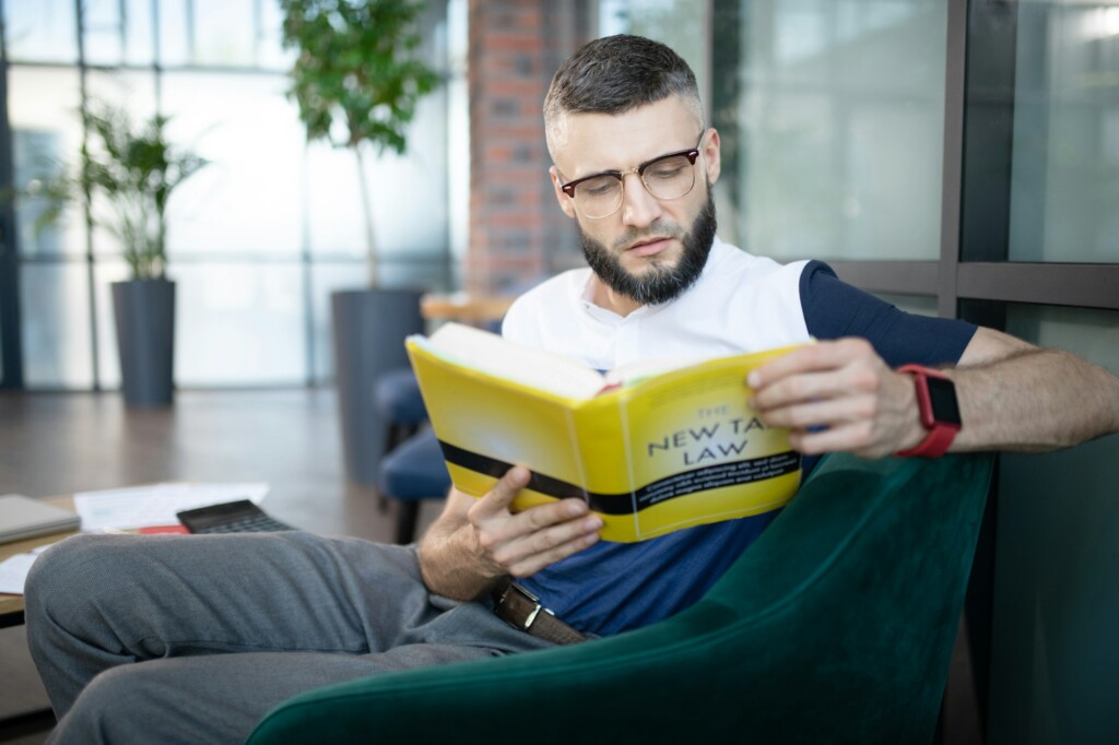 Smart businessman improving his knowledge about taxes