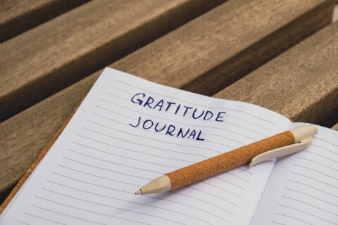 Writing Gratitude Journal on wooden bench. Today I am grateful for. Self discovery journal, self