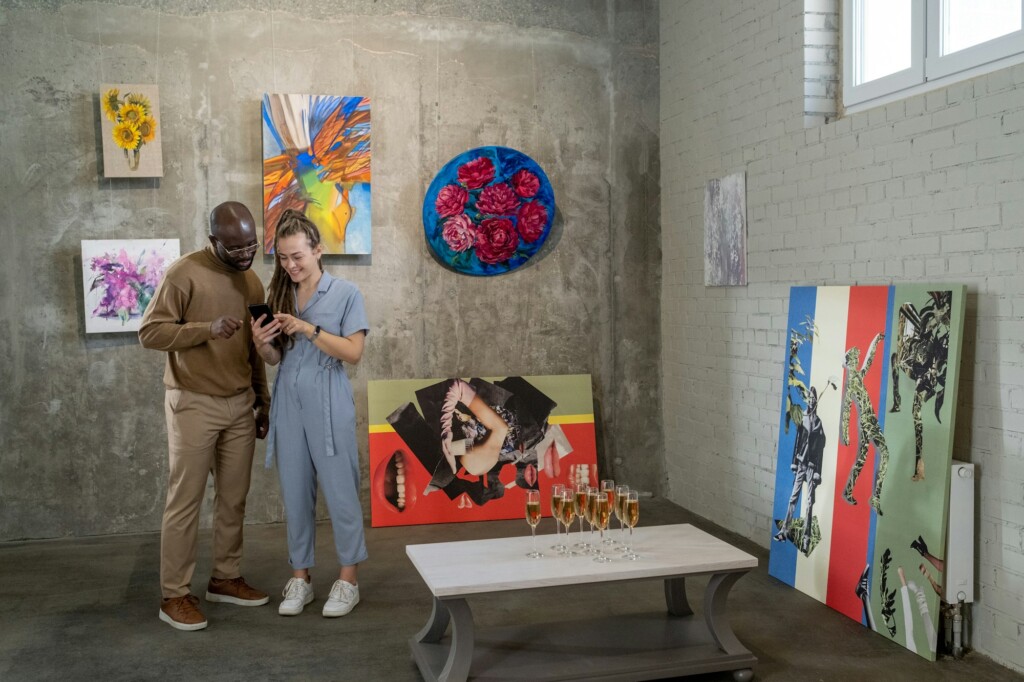 Young intercultural couple looking through their photos in smartphone