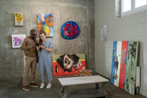 Young intercultural couple looking through their photos in smartphone