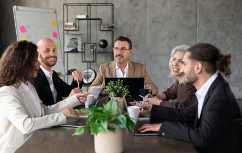 Business team strategizing in a meeting at table in office