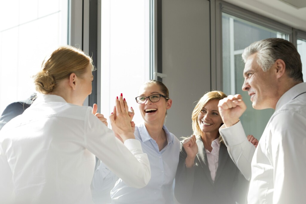 Laughing business people celebrating success