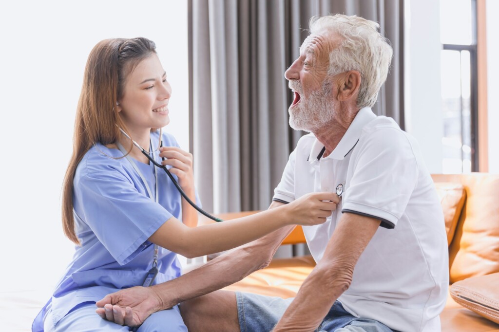 Nurse doctor working at home care medical checkup healthy elderly senior male happy smile